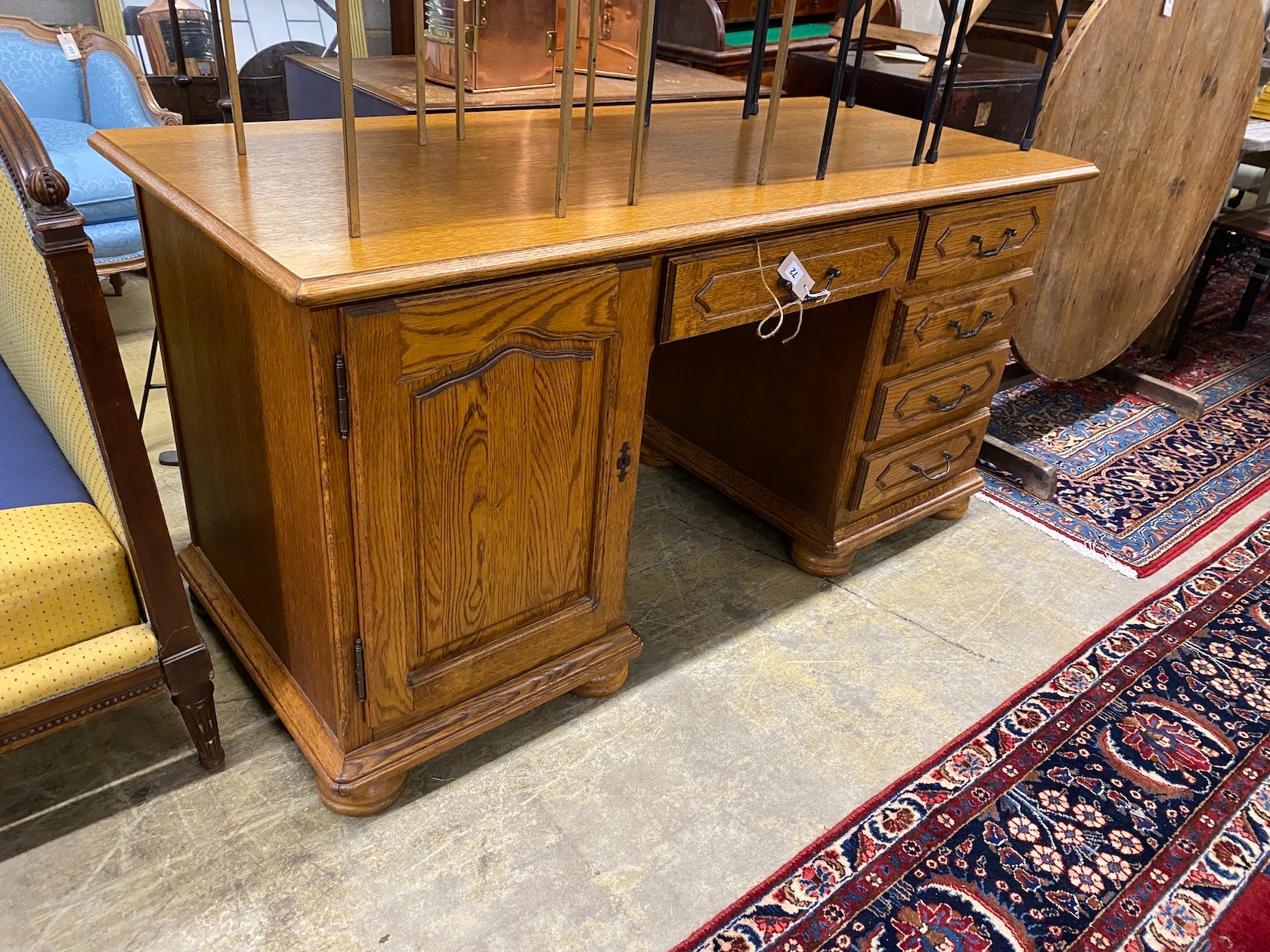 A reproduction French style oak kneehole desk, length 166cm, depth 69cm, height 79cm